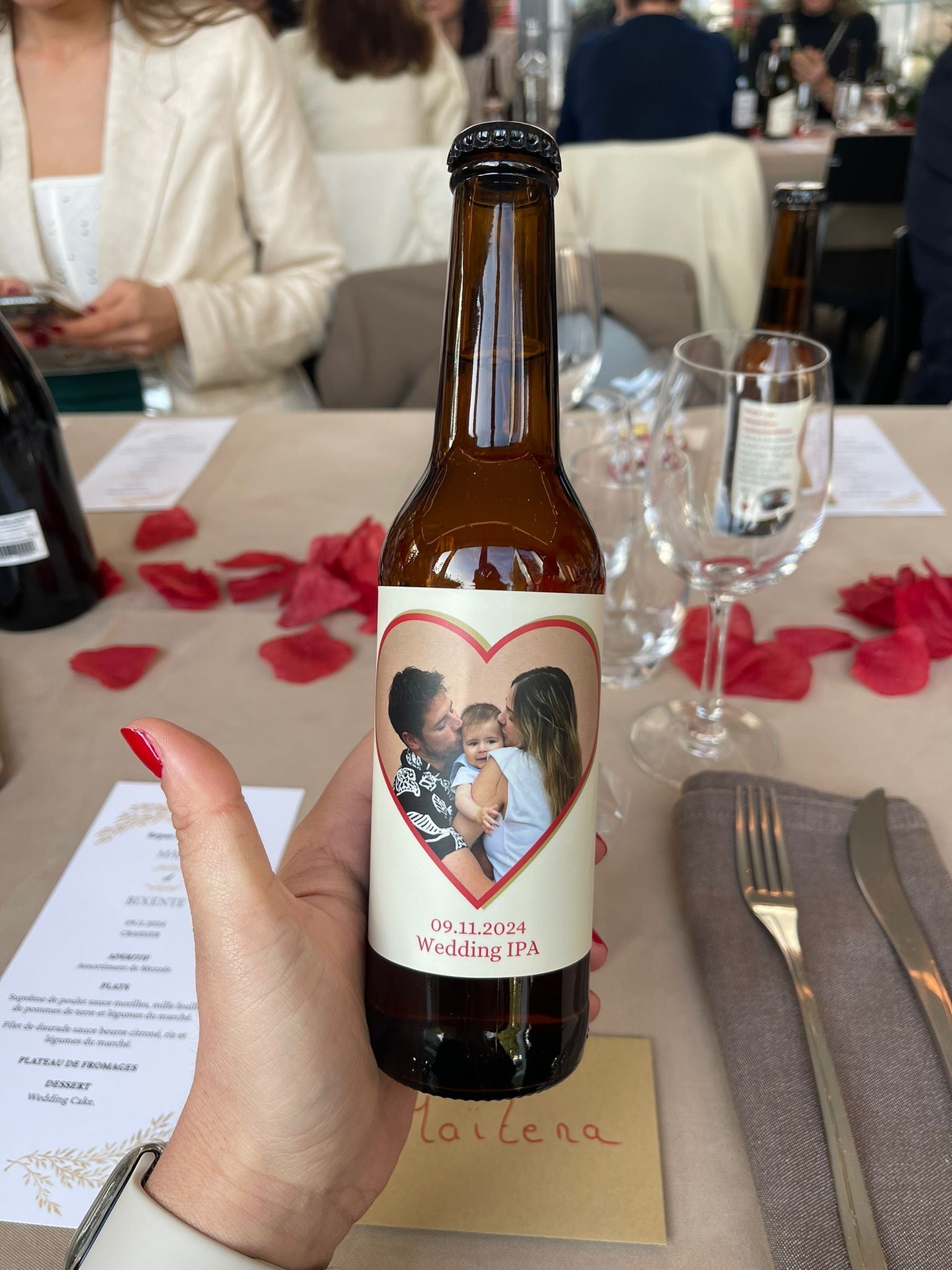 Bouteille Wedding IPA avec une étiquette romantique affichant un couple et leur enfant, ajoutant une dimension personnelle et genevoise à la célébration.